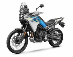 Adventure motorcycle shown in white and blue with a tall windscreen, rugged front fork, and knobby tires for off-road riding actions.