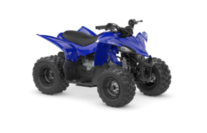 Blue Yamaha ATV (quad bike) with large knobby tires on a white background