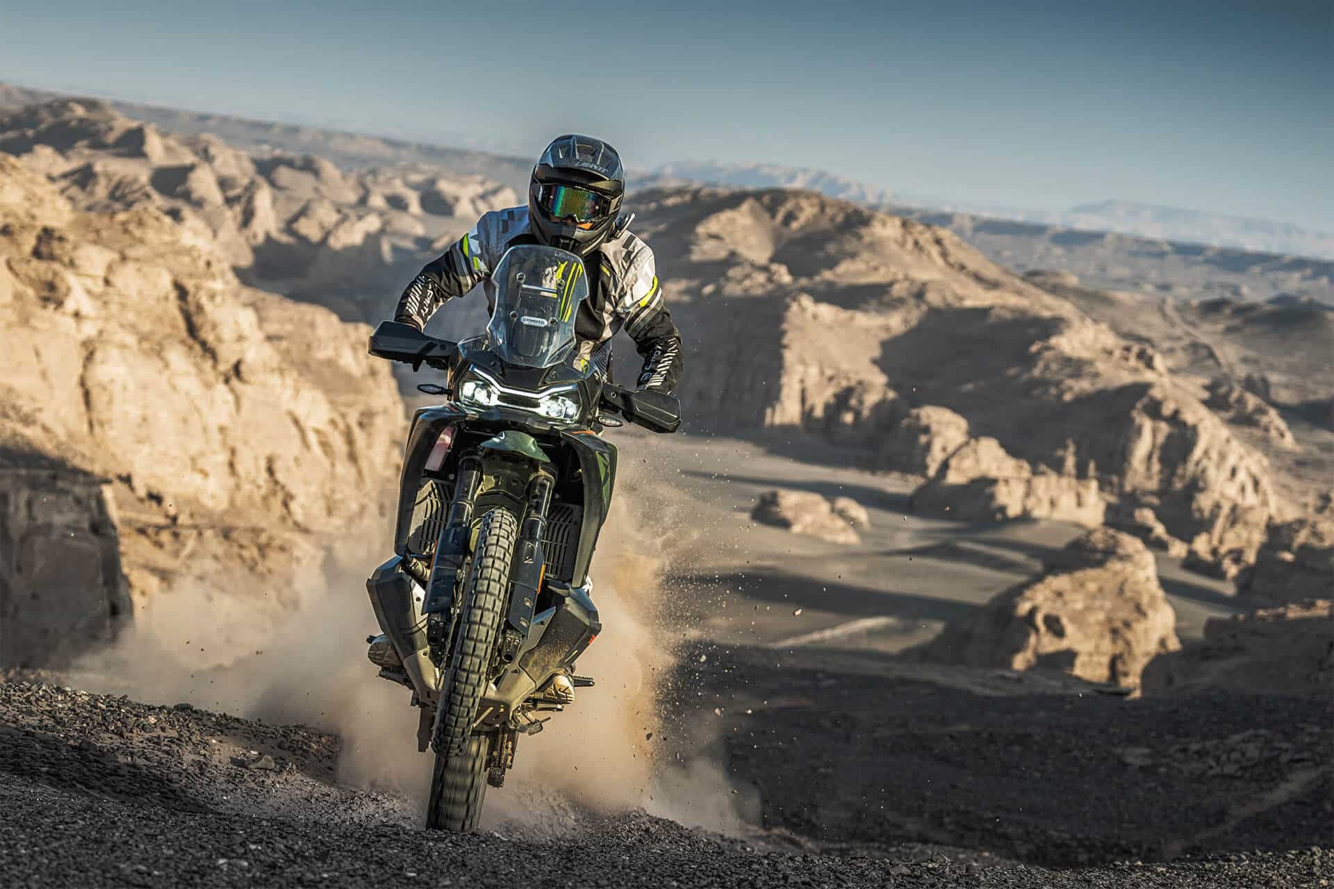 rieju-xplora-707-x 1 - AutoBike Off-road motorcyclist riding a dirt bike across rocky desert terrain, dust behind the wheels. - AutoBike