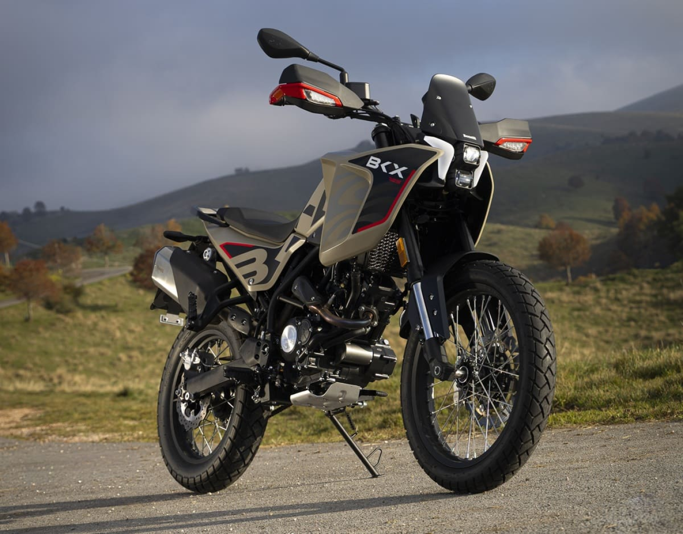 Benelli-bkx-125-s 4 - AutoBike Adventure motorcycle parked on a rural road with rolling hills in the background. - AutoBike