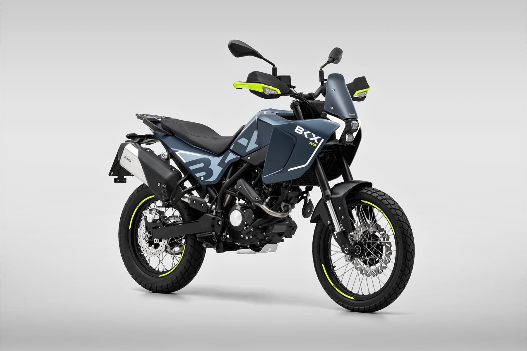 Benelli-bkx-125-s 6 - AutoBike Blue adventure motorcycle with neon yellow accents against a light gray studio background, angled to show side and front. - AutoBike