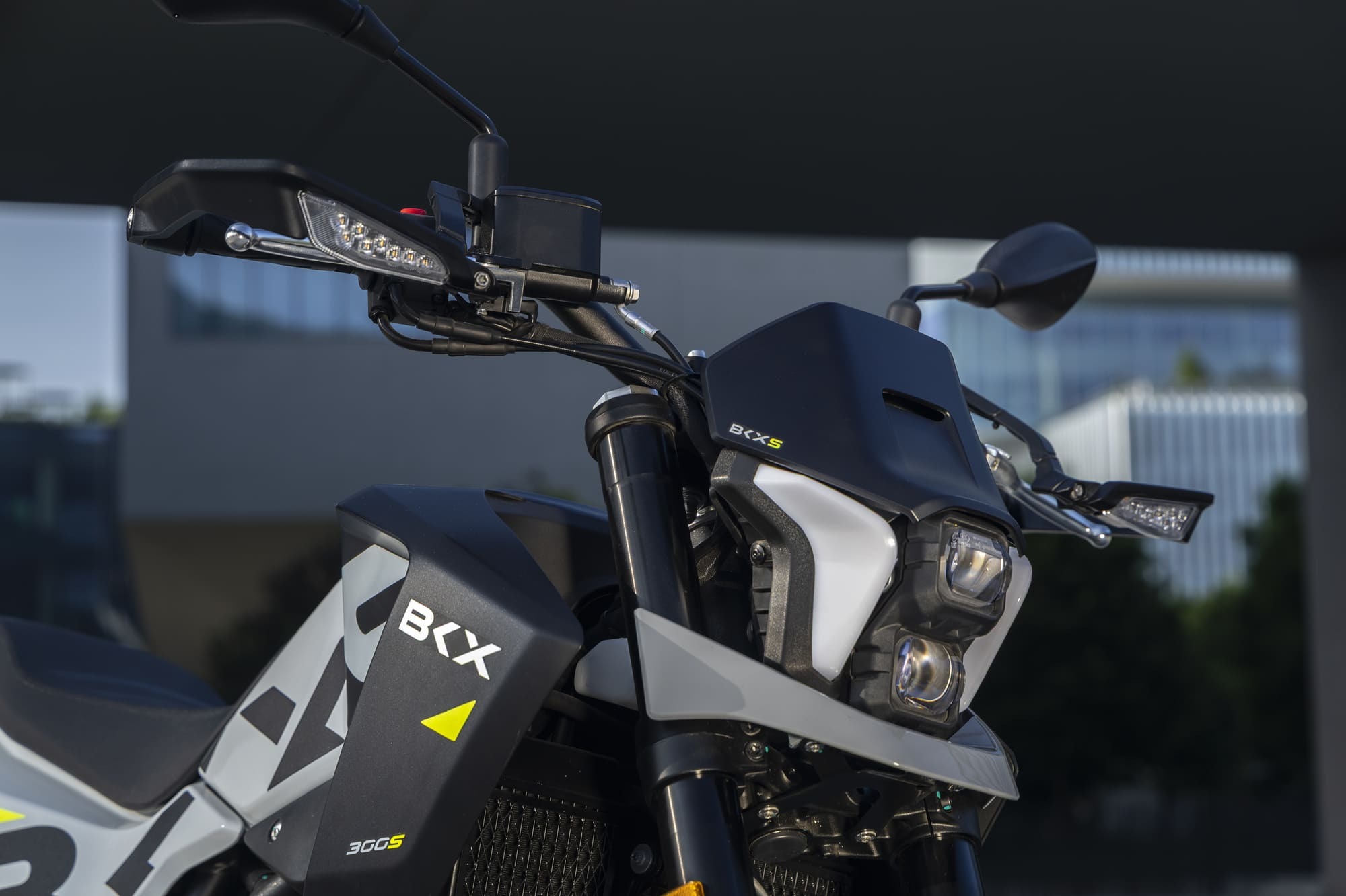 Benelli-bkx-300 2 - AutoBike Close-up of a black adventure motorcycle front with handlebars, LED light strip, and BKX branding on the fairing (360S badge visible) - AutoBike
