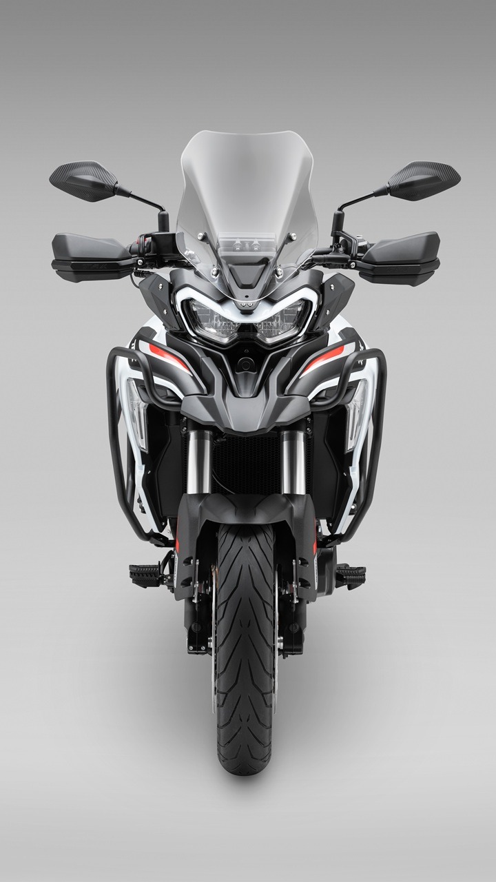 Benelli-trk-702 2 - AutoBike Front view of a grey adventure motorcycle with a tall windshield, dual LED headlights, and protective crash bars. - AutoBike