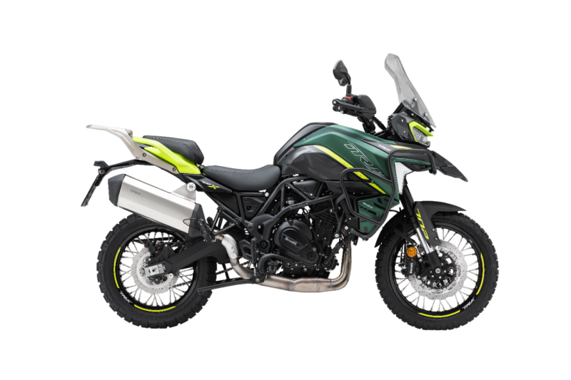 Benelli-trk-702 5 - AutoBike Green adventure motorcycle with a windscreen, knobby tires, and dual exhaust against a black background. - AutoBike