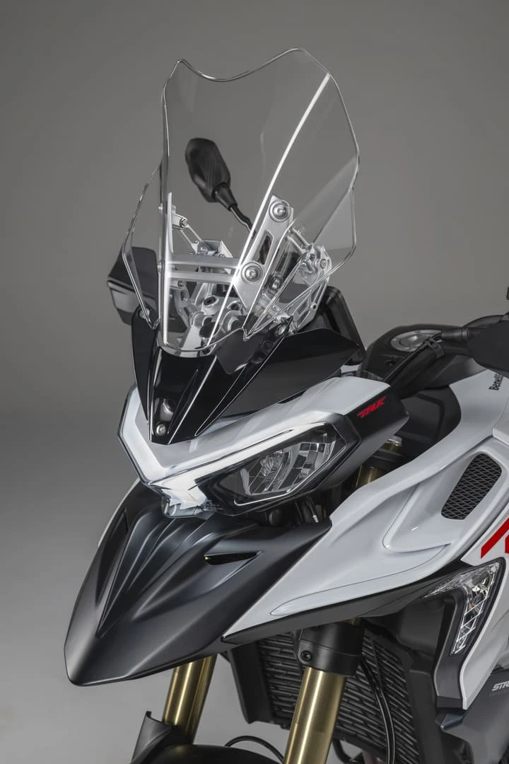 trk902stradale_22 - AutoBike Clear motorcycle windscreen mounted on a white and black adventure bike, showing the protective shield and front headlights clearly. - AutoBike