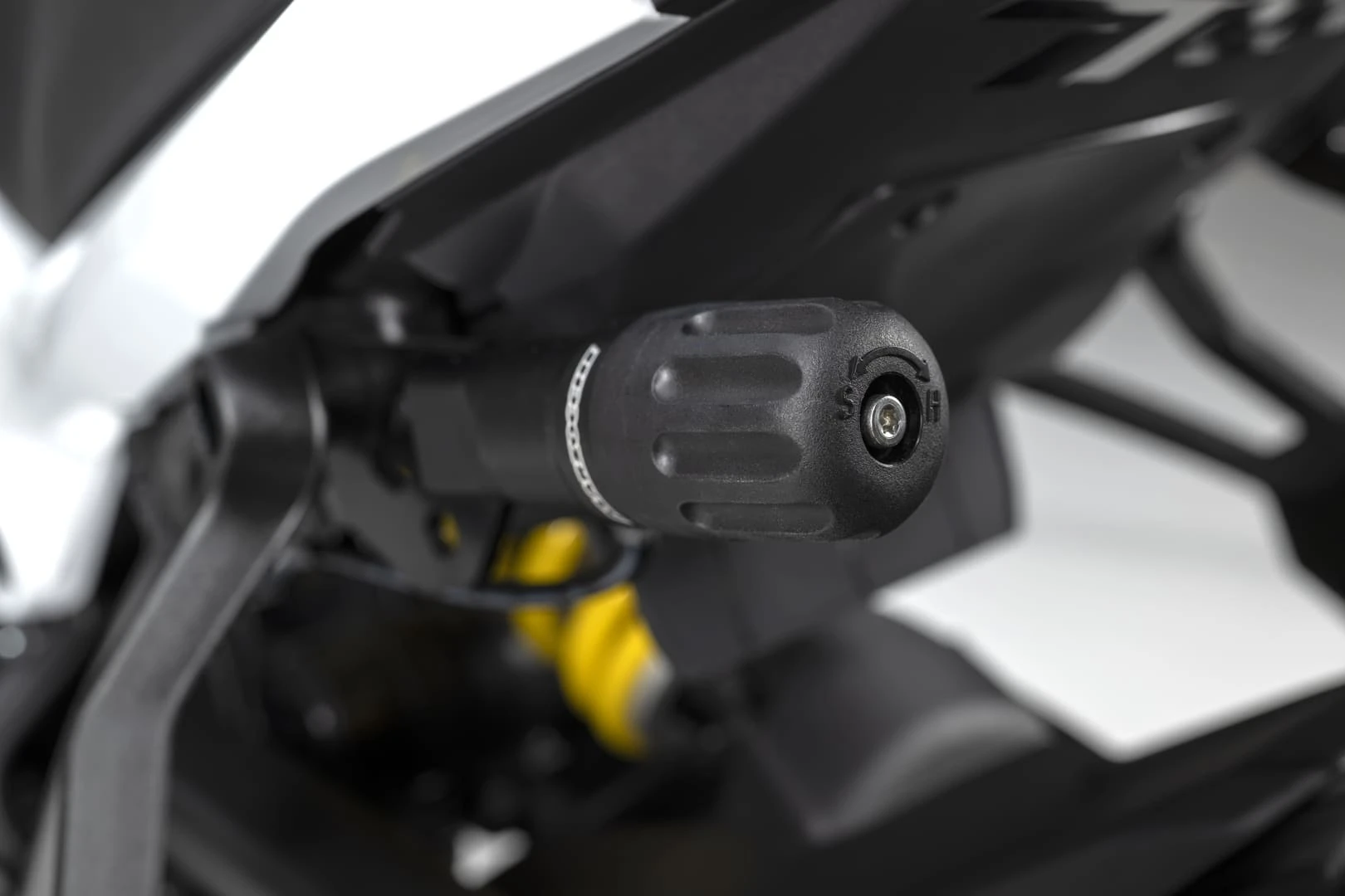trk902xplorer_21 - AutoBike Close-up of a black motorcycle handlebar grip with a visible end-screw. - AutoBike