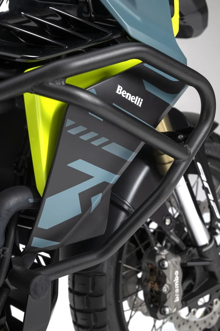trk902xplorer_24 - AutoBike Close-up of a Benelli motorcycle showing a protective crash bar, neon-green bodywork, and front-left area of the frame. - AutoBike